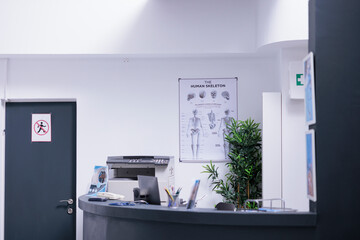 Poster with information about human body in medical clinic with empty reception counter. Front desk...