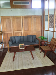 Interior of modern retro styled living room with armchair, table and decoration