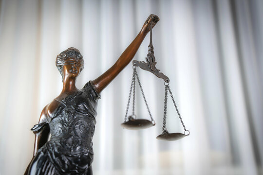 Statue of goddess of justice Themis on the light background.