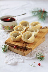 Homemade Christmas dumplings on a festive table, traditional Polish dumplings with cabbage and mushrooms, Christmas mood, culinary magazine.