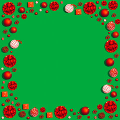 Christmas and New Year holiday background. Xmas greeting card. Red Christmas decoration on a green background. Noel. Top view. Flat lay.