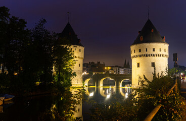 Illuminated night view of Broel Towers along the river Lys in Kortrijk, Belgium