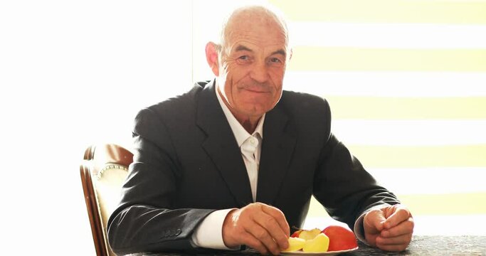 a man eats an apple and praises its taste