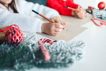 Children write a letter to Santa, festive atmospheric photo