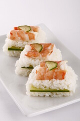Shrimp and cucumber sushi on a white plate