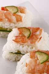 Shrimp and cucumber sushi on a white plate