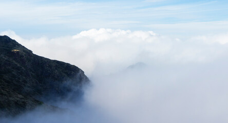 Side of a mountain with fog and clouds. Cloud banner copy space. 