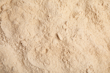Pile of sesame flour as background, top view