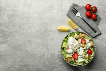 Delicious salad with Chinese cabbage, cucumber, meat and tomatoes served on grey table, flat lay. Space for text