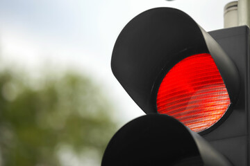 Closeup view of red traffic light in city. Space for text