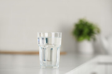 Glass of pure water on table indoors