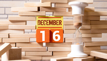 December 16 vintage wooden block calendar, festive bokeh lights background, sweet sixteen
