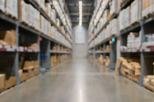 Blurred industrial warehouse or  storage factory space and hardware box for delivery with logistics concept for business.