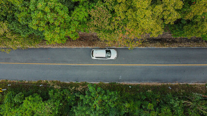 Aerial view asphalt road through green tropical rainforest nature landscape.
