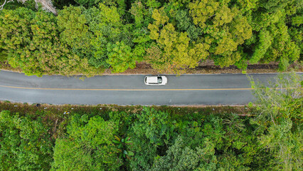 Aerial view asphalt road through green tropical rainforest nature landscape.