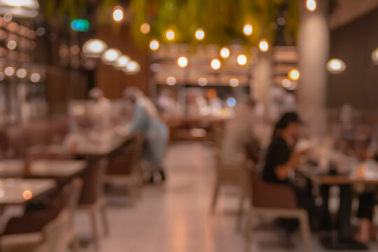 Blurred customers and employee in the restaurant with bokeh. vintage photo.