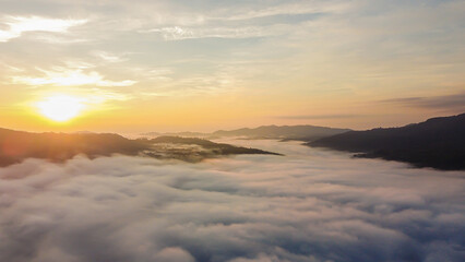 Thick fog in the mountains at dawn, Beautiful  sunrise and fog landscape.