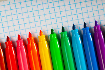 Image of opened multicolored markers on notepad, nobody