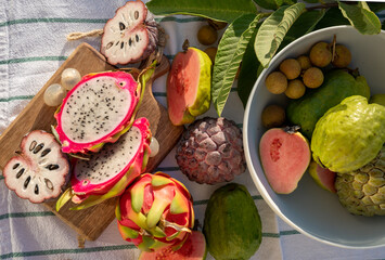 Variaty of tropical exotic fruits, ripe fresh lychee, dragon fruit, guava and cherimoya
