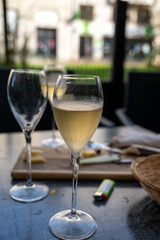 Tasting of white brut champagne wine outdoor in cafe in Reims, Champagne, France
