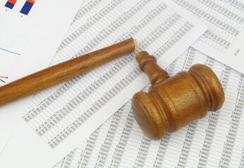 Fototapeta premium Broken wooden gavel on financial data. Bad audition and injustice concept. 