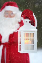 Santa Claus with bag of Christmas gifts is walking through snowy forest. Animator or parent in...