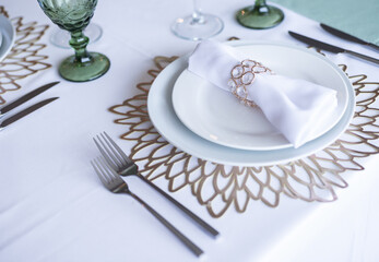 
Serving and decoration of the wedding table. Glasses, spoons, forks and white napkins