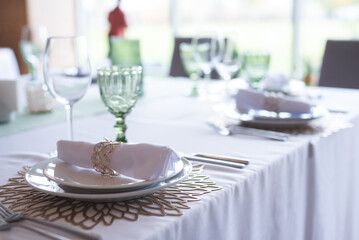 
Serving and decoration of the wedding table. Glasses, spoons, forks and white napkins