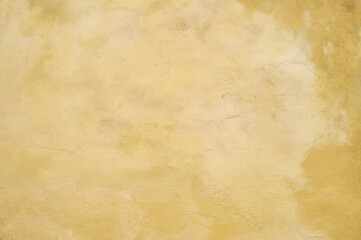 Textured wall in shades of yellow paint, as a graphic background
