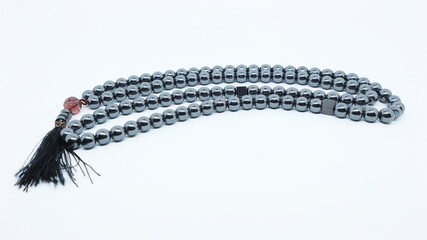 tasbih from silver berries as a counting tool in Muslim worship after praying isolated white