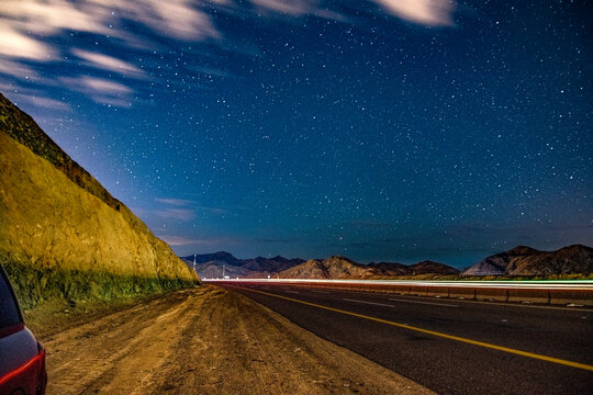 Hail, Medina, Saudi Arabia. February 1st, 2022. A night shots on the highway. Long exposure photo that shows night lights and stars.