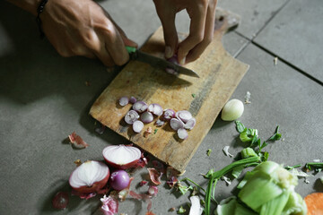 sliced ​​red onion with some seeds on concrete background