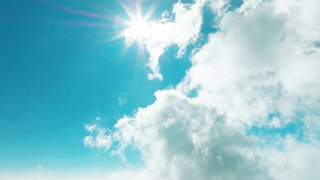 Aerial view of  blue sky with clouds and sun shining
