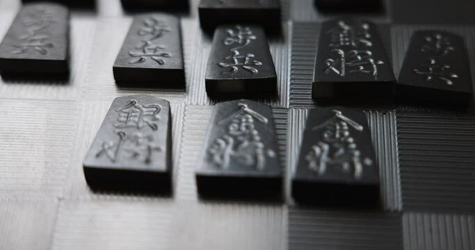 Piece of Shogi (made of titanium) on titanium plate. Shogi is the traditional chess of Japan.