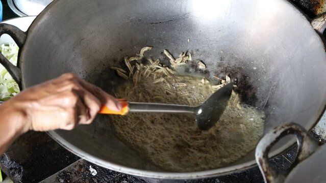 Cooking proccess of Fried anchovy. Cooking anchovy in a pan