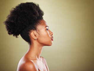 Black woman, hair and profile in studio for beauty, hair care and wellness with skin glow, shine...
