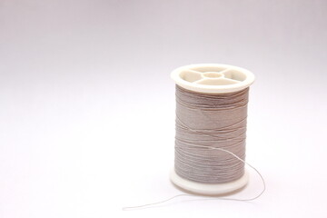Gray spools placed on a white background.