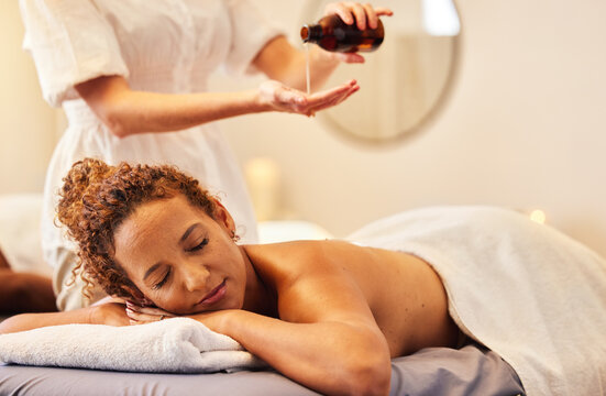 Spa, Luxury Massage And Woman With Essential Oil Getting Back Massage For Wellness In Beauty Salon. Health, Beauty And Black Woman With Massage Therapist For Relaxation, Stress Relief And Body Care