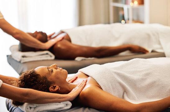 Spa, relax and couple massage for luxury wellness therapy or skincare health with masseuse hands. Zen physcial therapy, African man and woman body detox and peace at beauty salon for calm bodycare