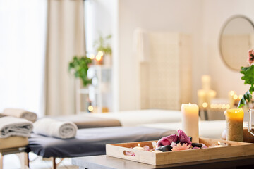 Candle, spa and relax with aromatherapy treatment in a tray in a room for luxury or wellness....