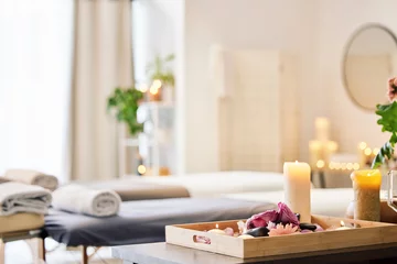 Papier Peint photo Salon de massage Candle, spa and relax with aromatherapy treatment in a tray in a room for luxury or wellness. Background, health and massage with still life in an empty resort for peace, skincare or relaxation