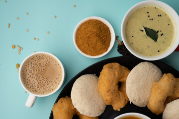 south indian food called idli vada sambar or sambar vada or wada, served with coconut chutney and south indian style hot coffee