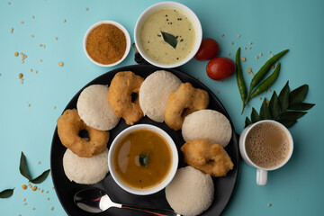 south indian food called idli vada sambar or sambar vada or wada, served with coconut chutney and south indian style hot coffee