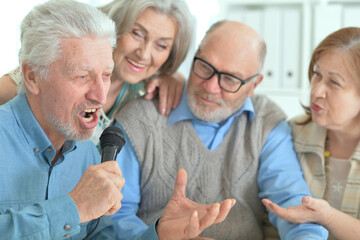 two senior couples singing karaoke
