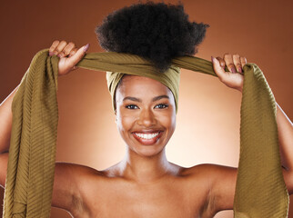 Face, beauty and black woman with hair scarf in studio on brown background. Fashion, hair care and...