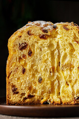 Close up of Panettone, Italian Christmas cake with raisins and candied fruits cut in half . Cake...