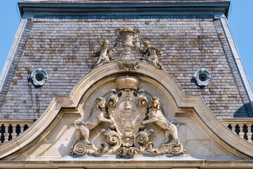 Rampant lions hold up the coat of arms of Festetics family on the tower of  Festetics Palace -...