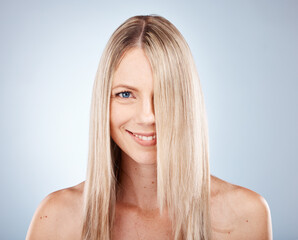 Fototapeta premium Hair, woman and portrait of blond lady with healthy hair for beauty and haircare. Hair care, hairstyle and face of blonde female for cosmetology or wellness on a grey studio background