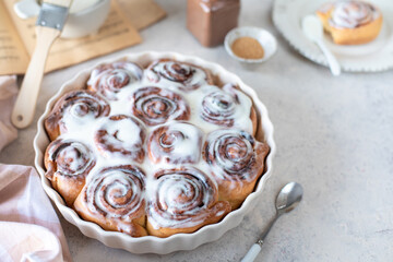 Traditional cinnamon buns on a white table, homemade sweet buns.