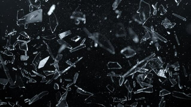 Super Slow Motion Shot of Glass Shards Flying Towards Camera Isolated on Black at 1000fps.